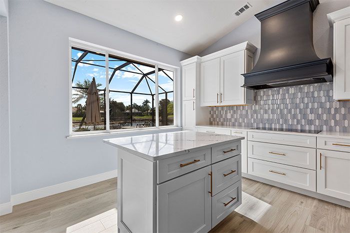 There is a large island in the middle of the kitchen.