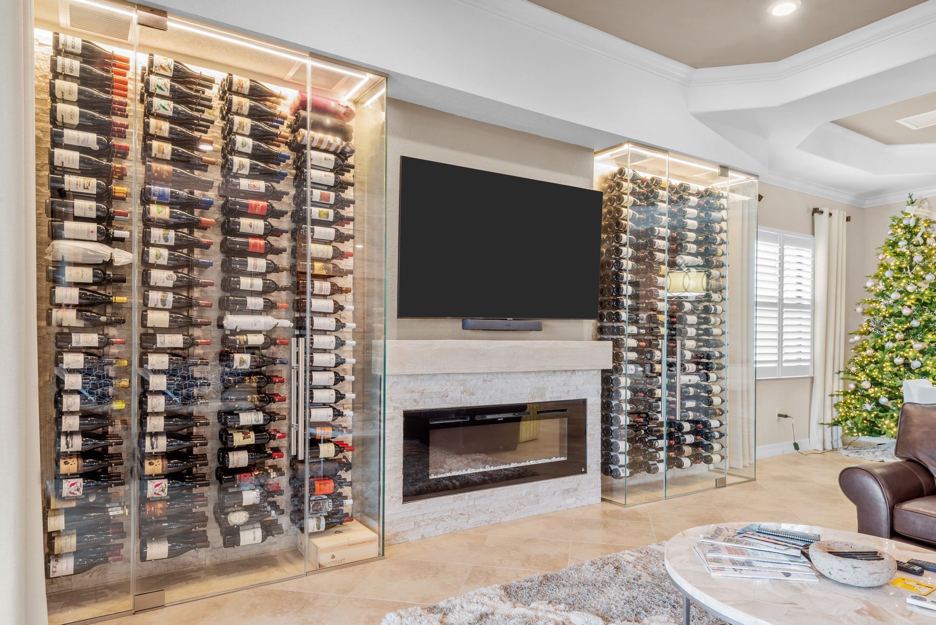 A living room with a wine cellar and a flat screen tv.