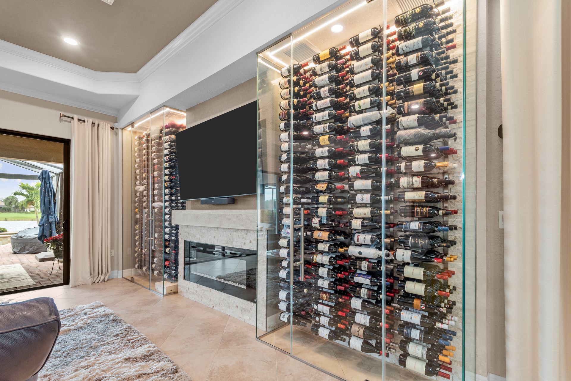 A living room with a wine cellar and a fireplace.
