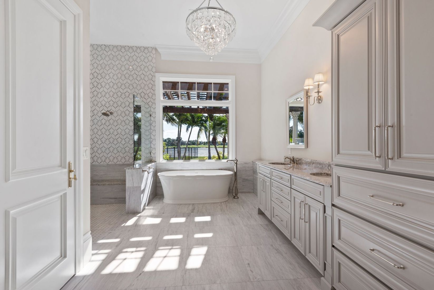 A bathroom with a bathtub and a large window