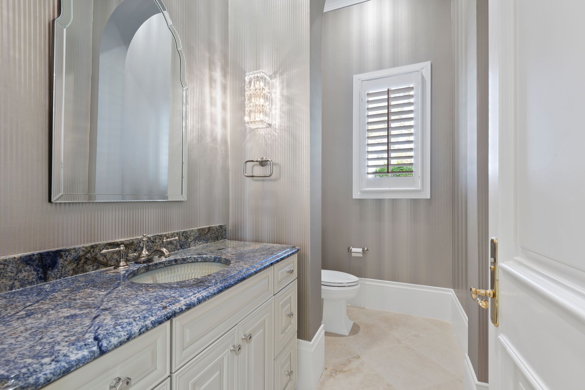A bathroom with a sink , toilet and mirror