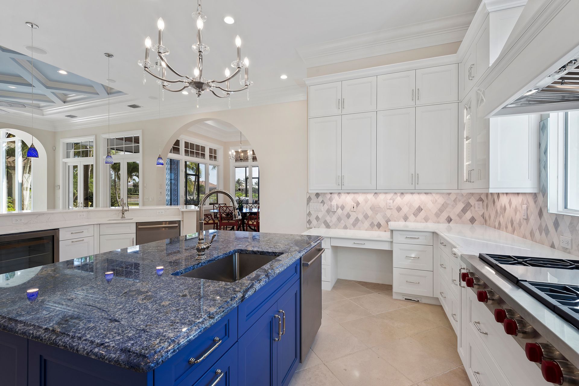 A kitchen with blue cabinets and granite counter tops.