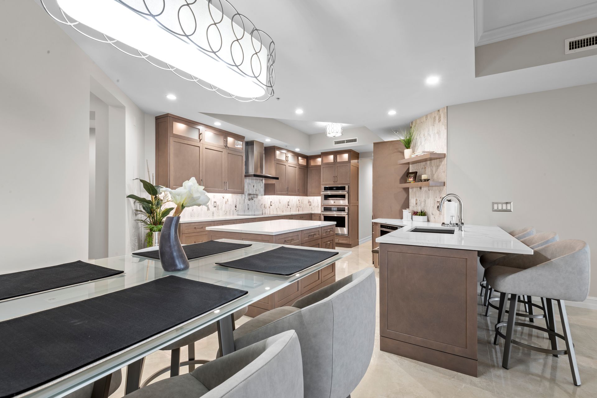 A kitchen and dining room in a house with a table and chairs.