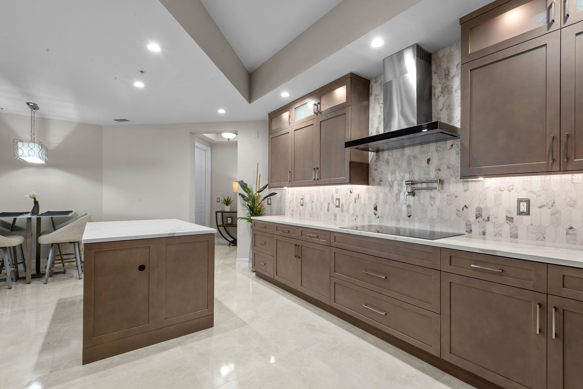 A kitchen with brown cabinets and a large island.