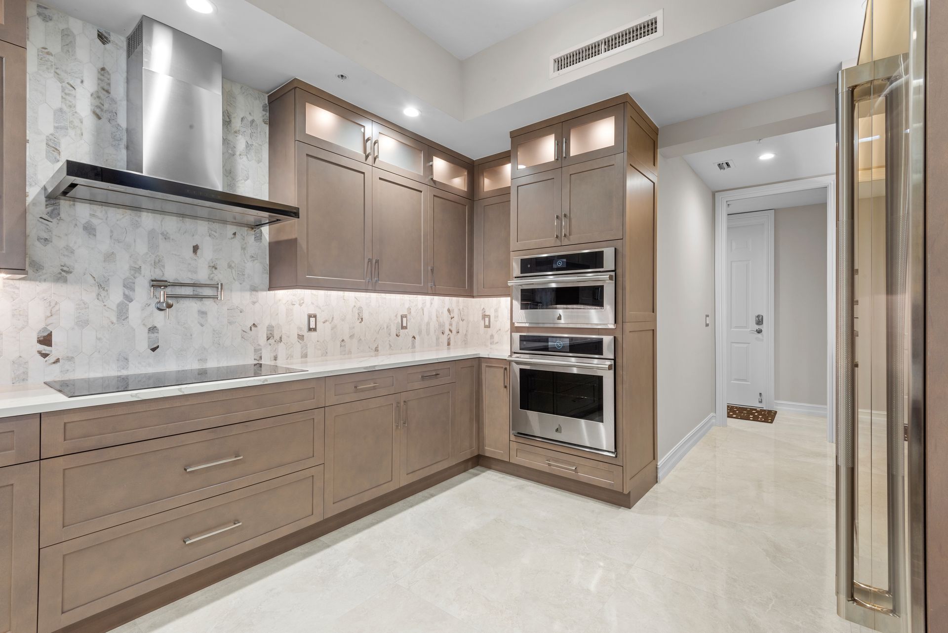 A kitchen with stainless steel appliances and wooden cabinets