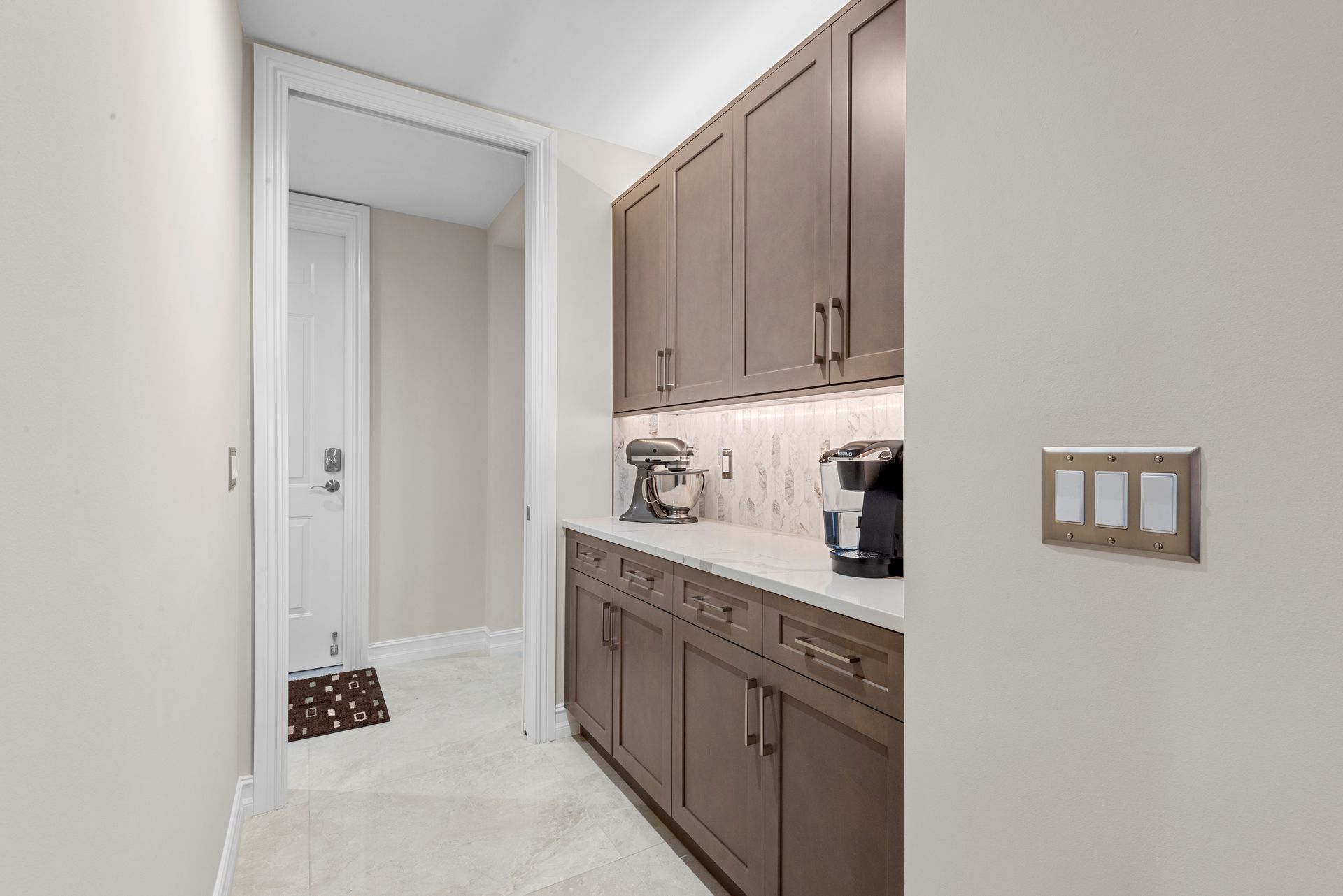 A kitchen with brown cabinets and white counter tops.