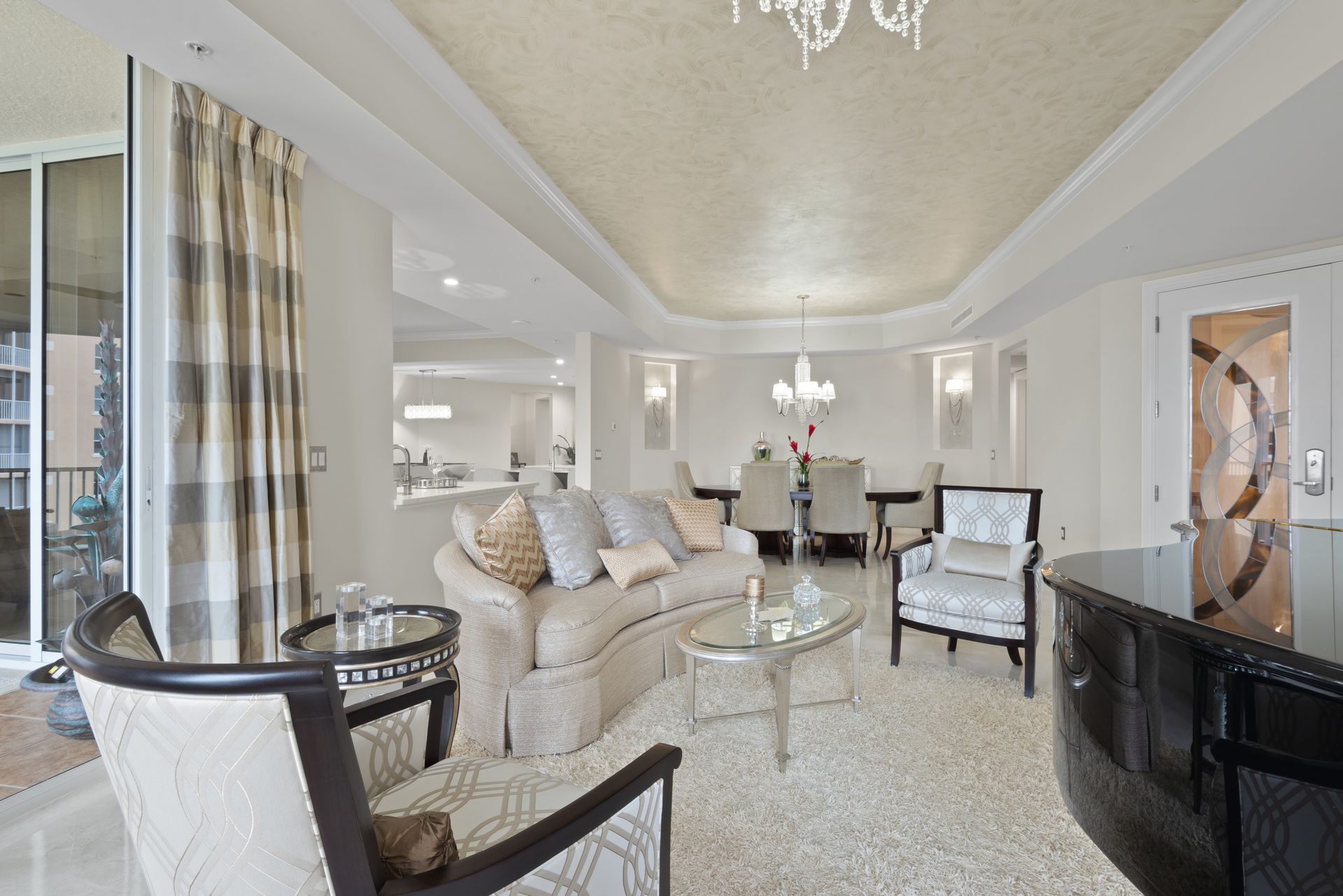 A living room with a couch and chairs and a piano