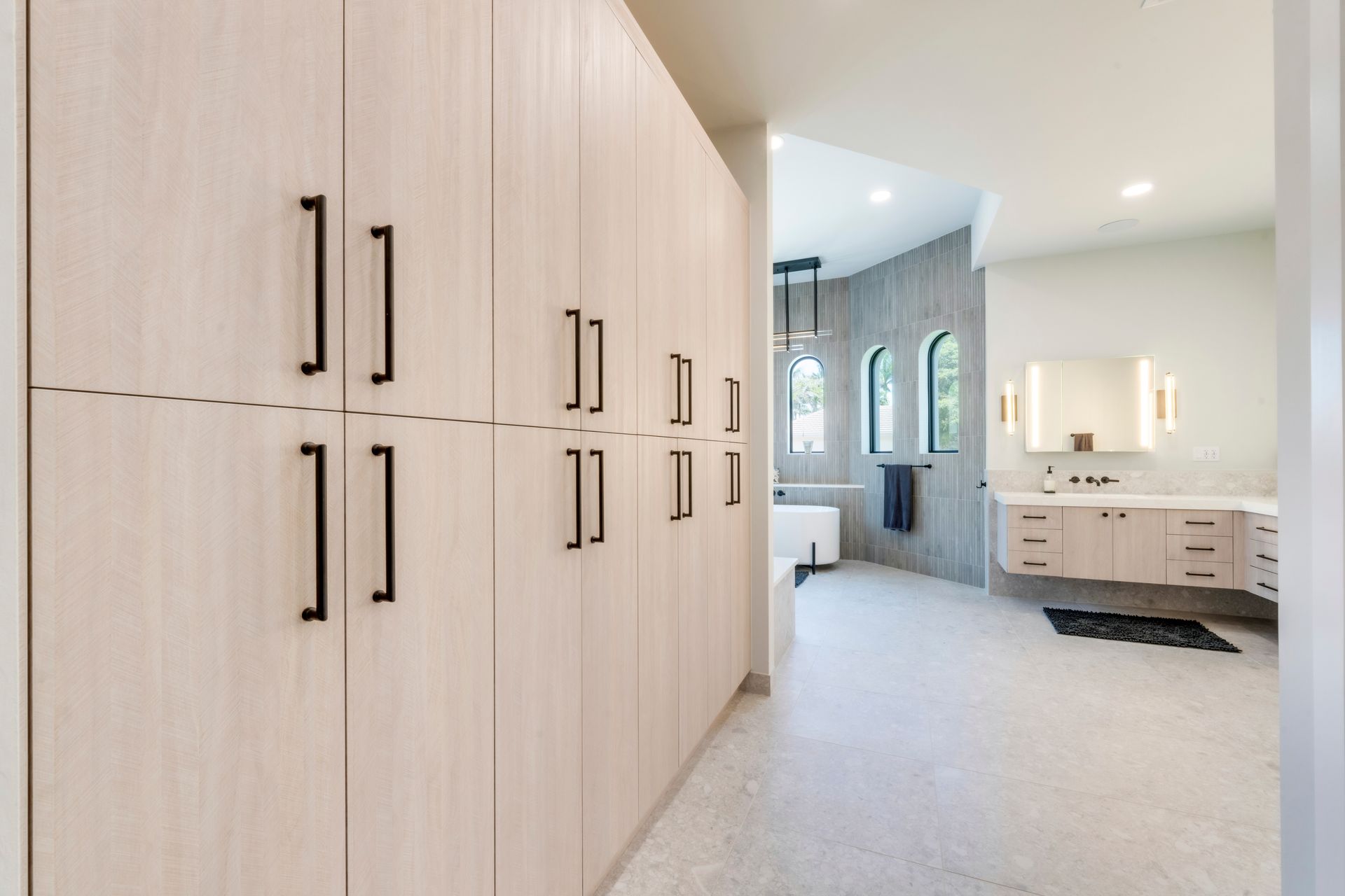 A bathroom with a lot of cabinets and a sink