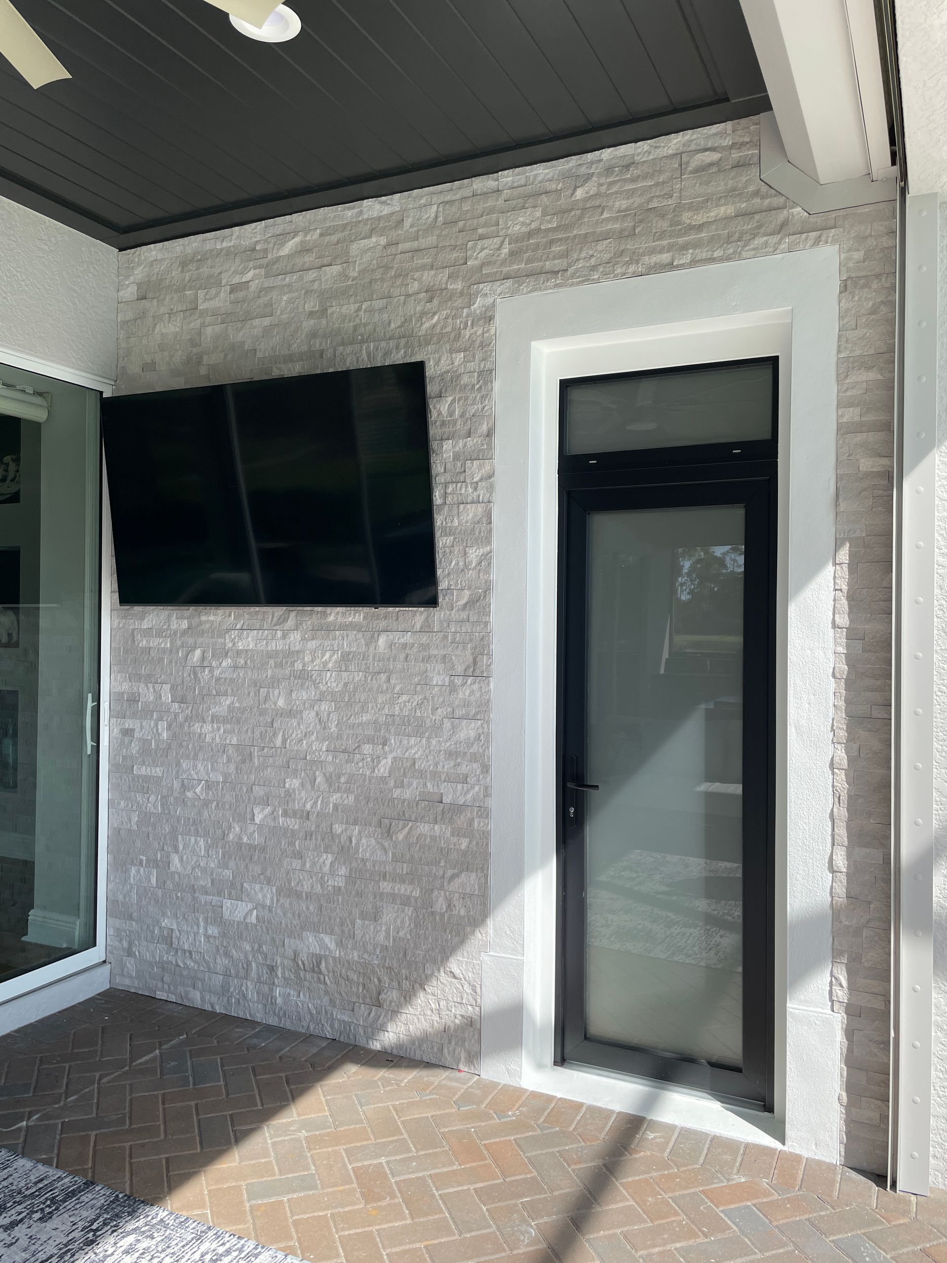 There is a tv on the wall above the door.