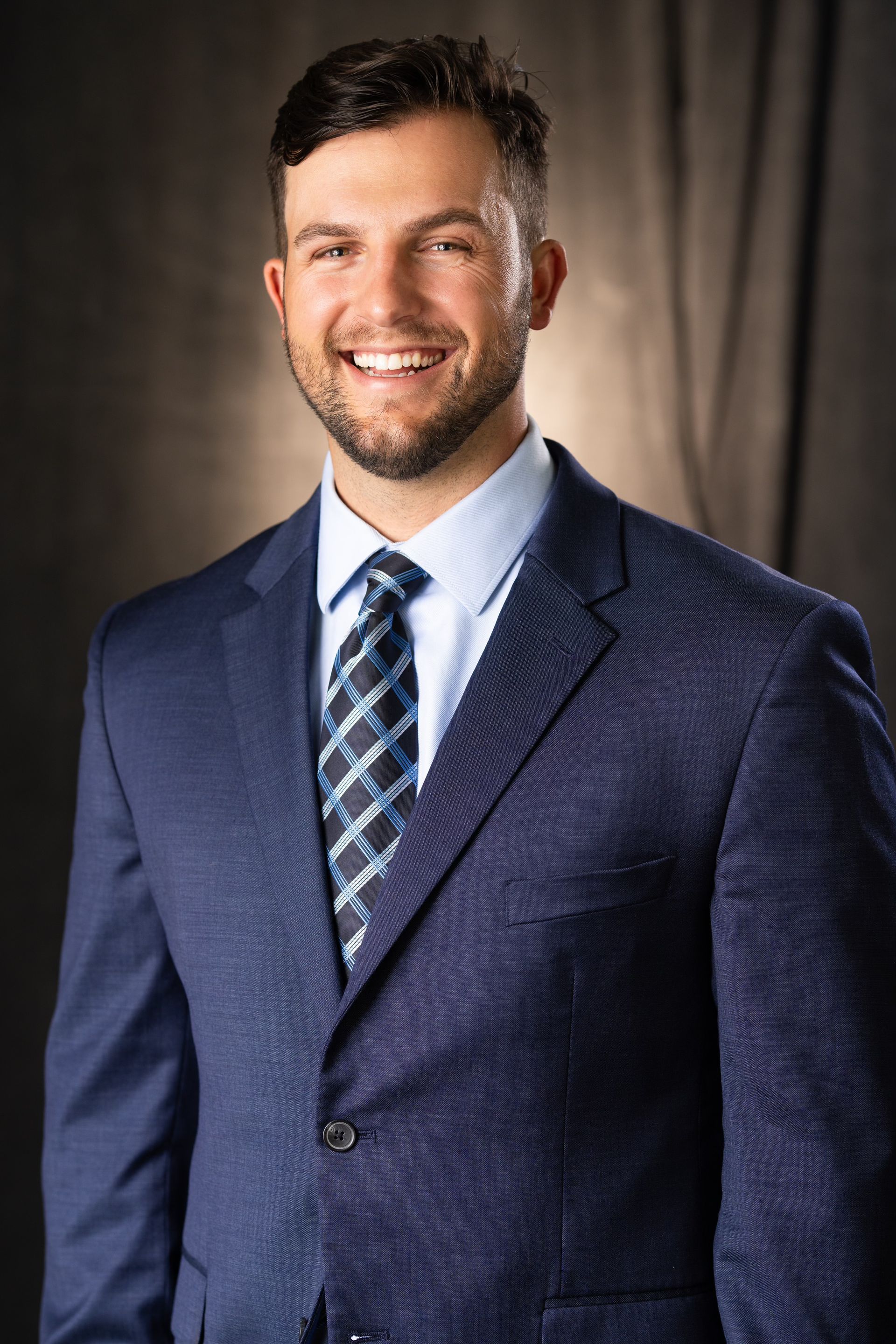 The woman is wearing a black shirt and smiling for the camera.
