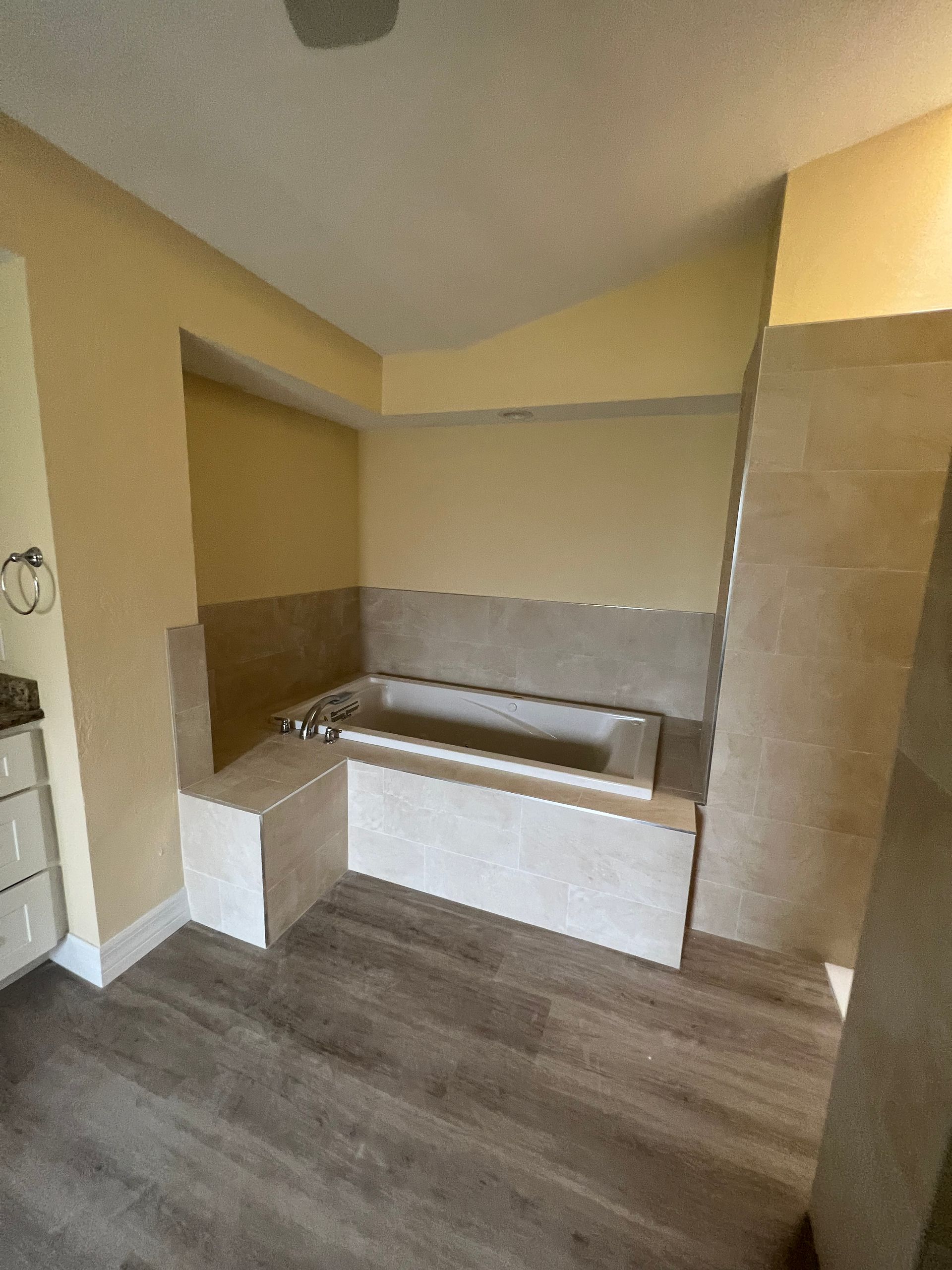 There is a bathtub in the middle of the bathroom.