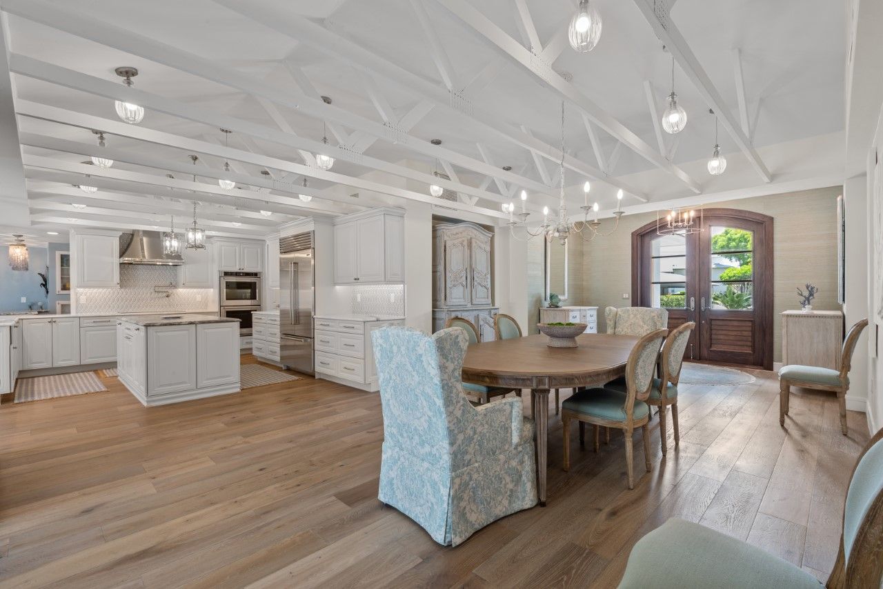 There is a table and chairs in the middle of the room.