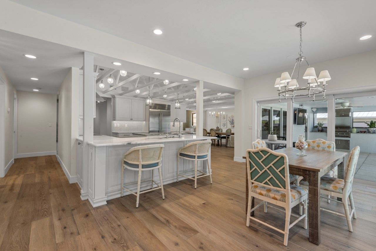 There is a table and chairs in the middle of the room.