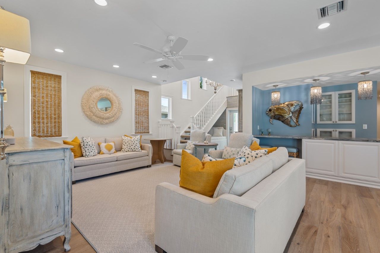 A living room filled with furniture and a ceiling fan.