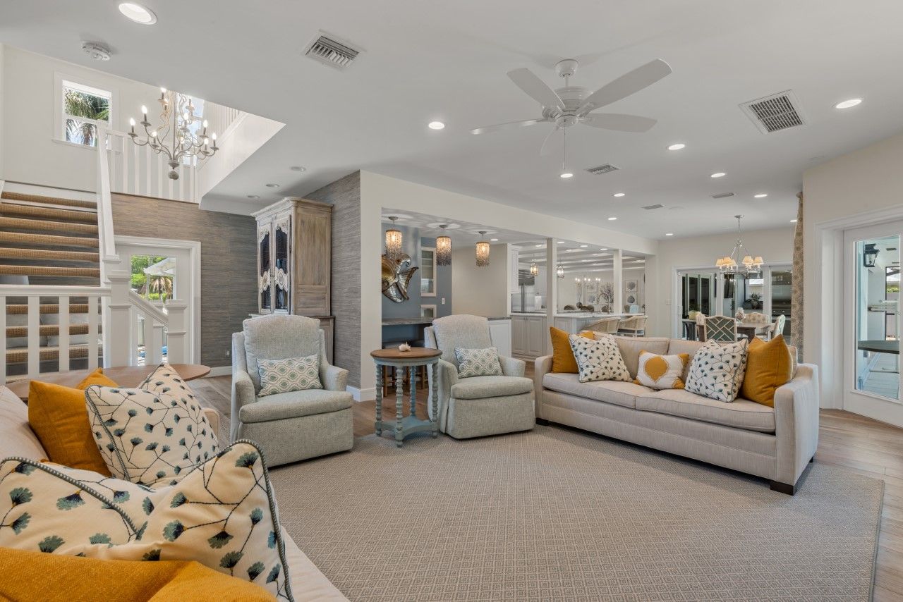 A living room filled with furniture and a ceiling fan.
