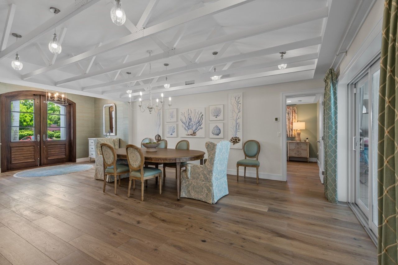 A large dining room with a wooden table and chairs.