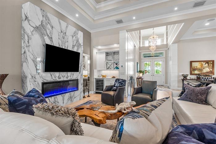 A living room with a fireplace and a flat screen tv.