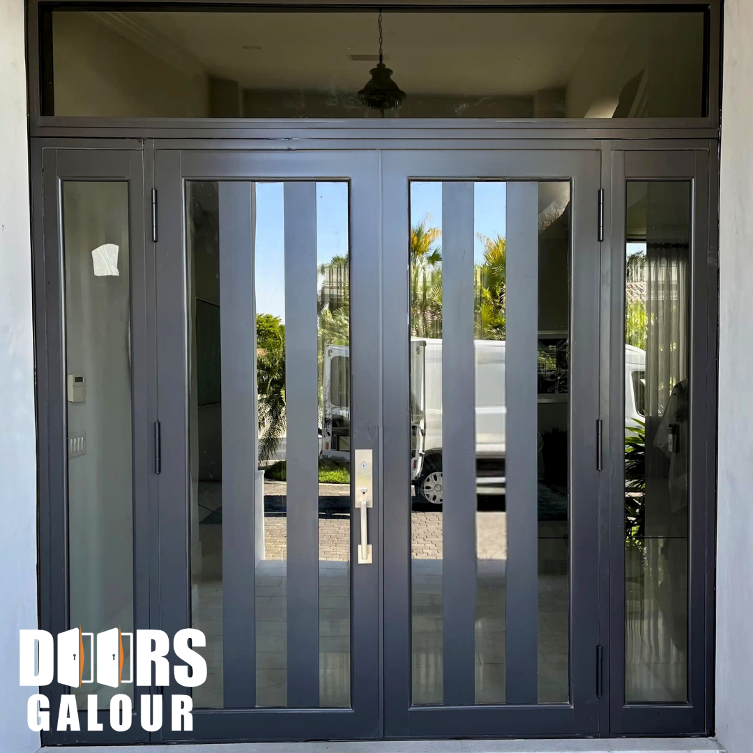 Gray double doors with vertical glass panels, sidelights, and transom. Exterior view.