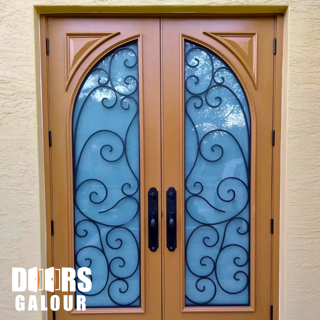 Double wooden doors with arched glass panels, black iron scrollwork, and dark handles.