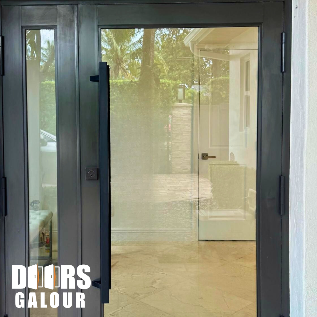 Glass double doors with black frames and long handles open to reveal a bright interior.