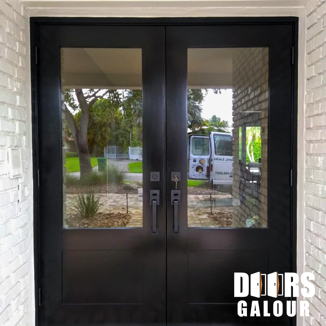 Black double doors with glass panels; entry to a building.