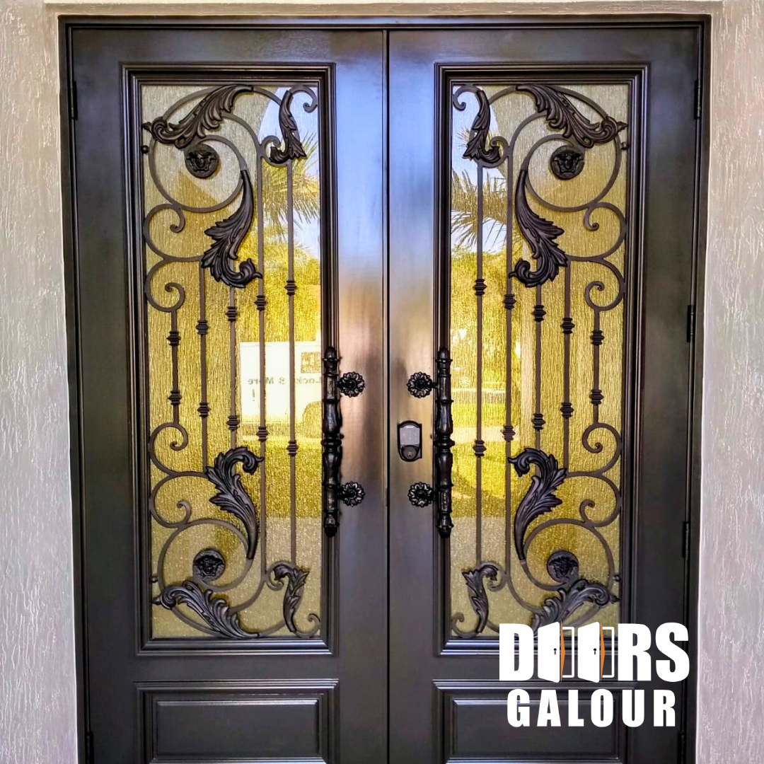 Double dark metal doors with ornate black scrollwork and glass panels.