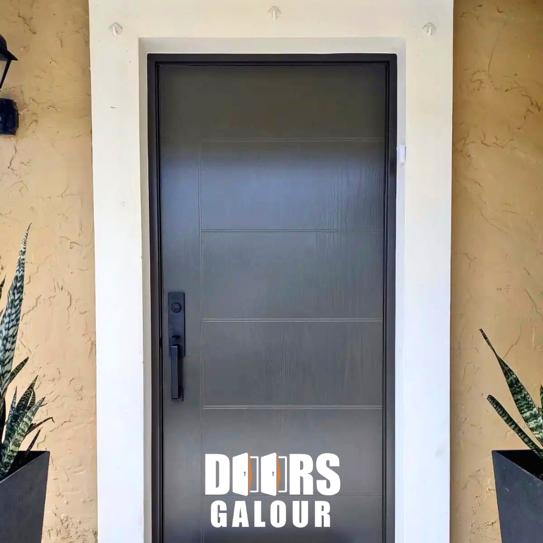 Dark gray door in white frame with black handle. Two potted plants on either side.