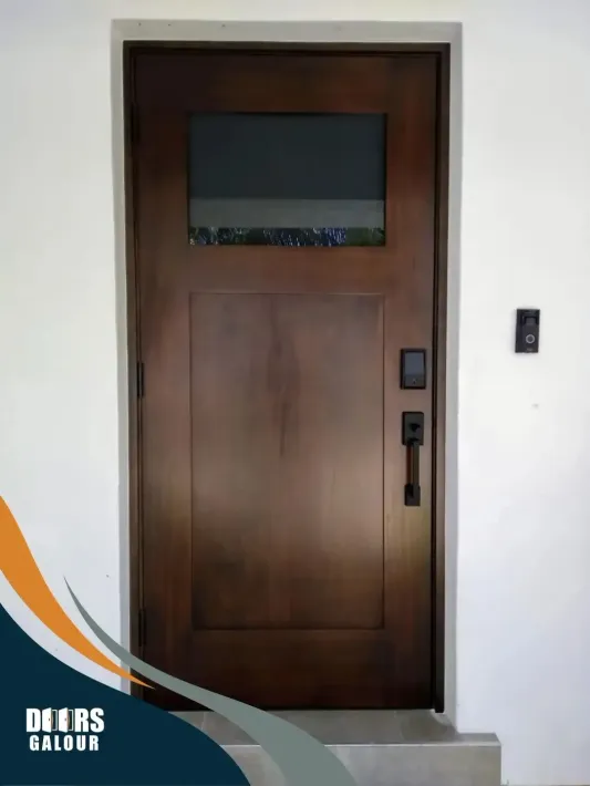 A picture of a wooden door with a glass window and the top.