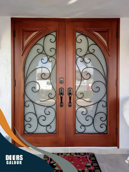 A wooden door with an elegant wrought iron design on it