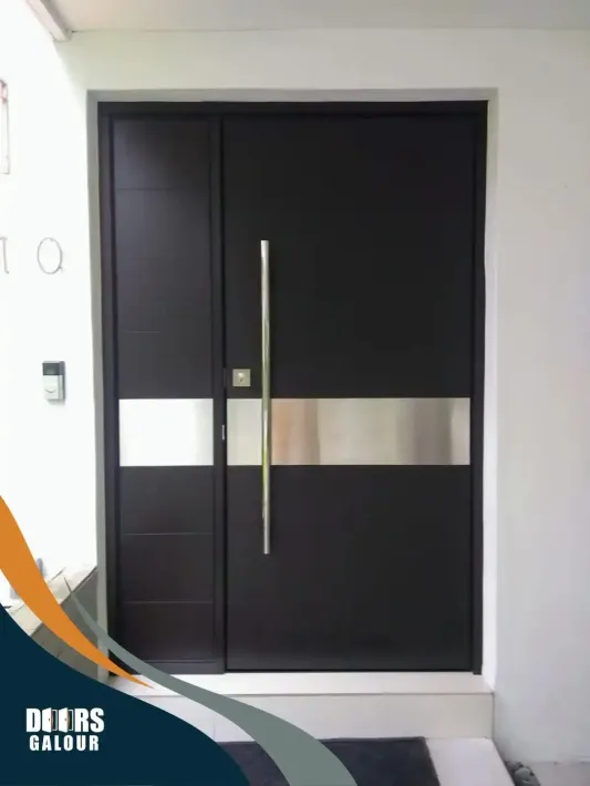 A black door with a stainless steel handle and a staineless steel cover in the middle.