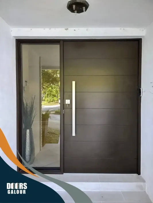 A large black door with a handle and a glass door