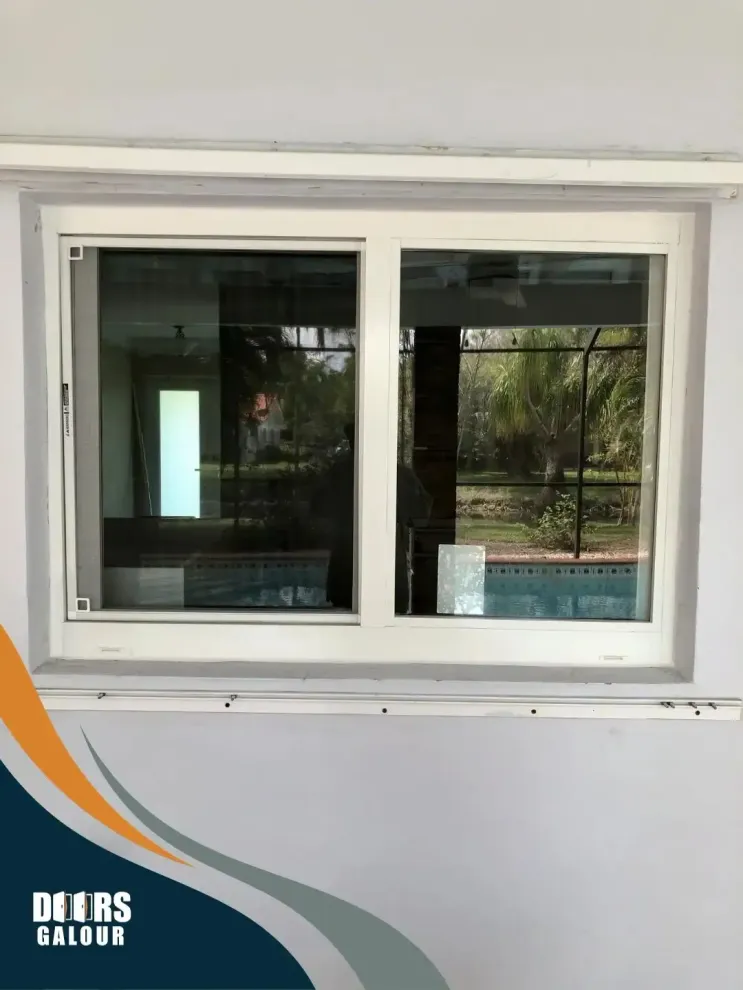 A white window with a view of a swimming pool