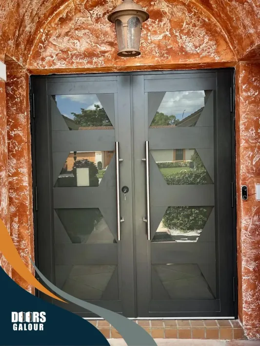 A black double door with a lantern on top of it