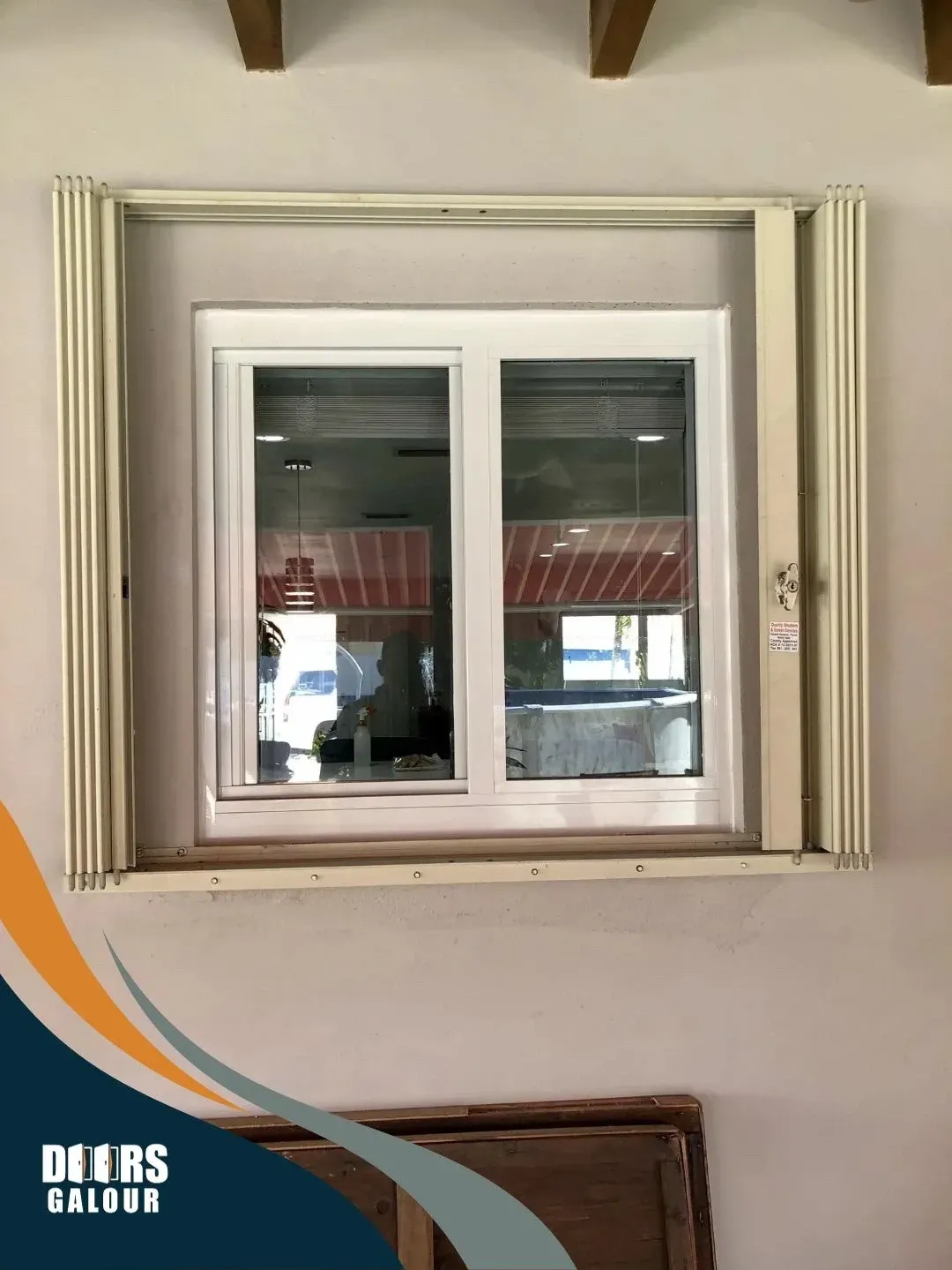 Impact white window installed in a beige wall, with a decorative frame around it.