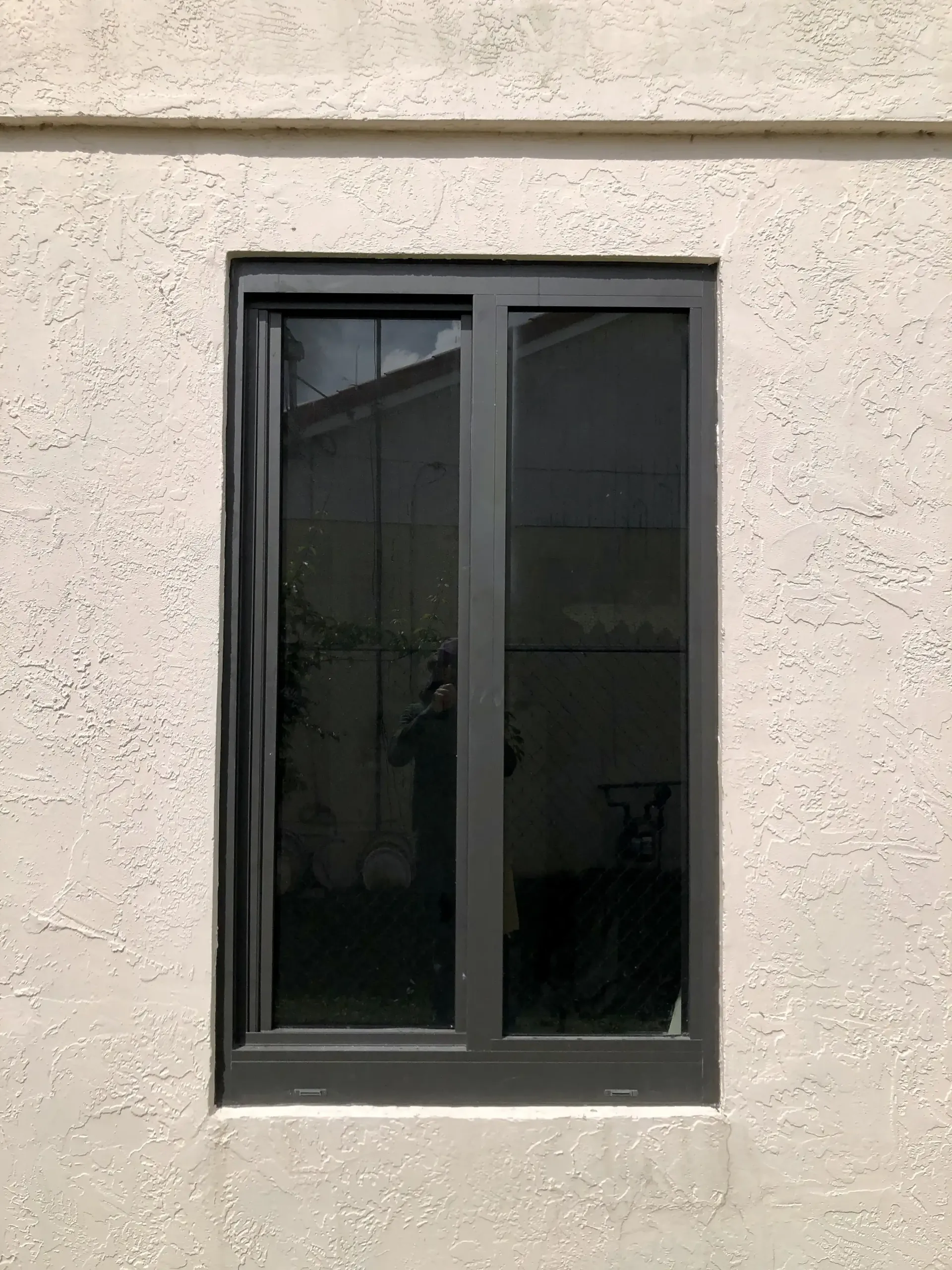 A stylish Sliding Impact Window near a lamp in South Florida