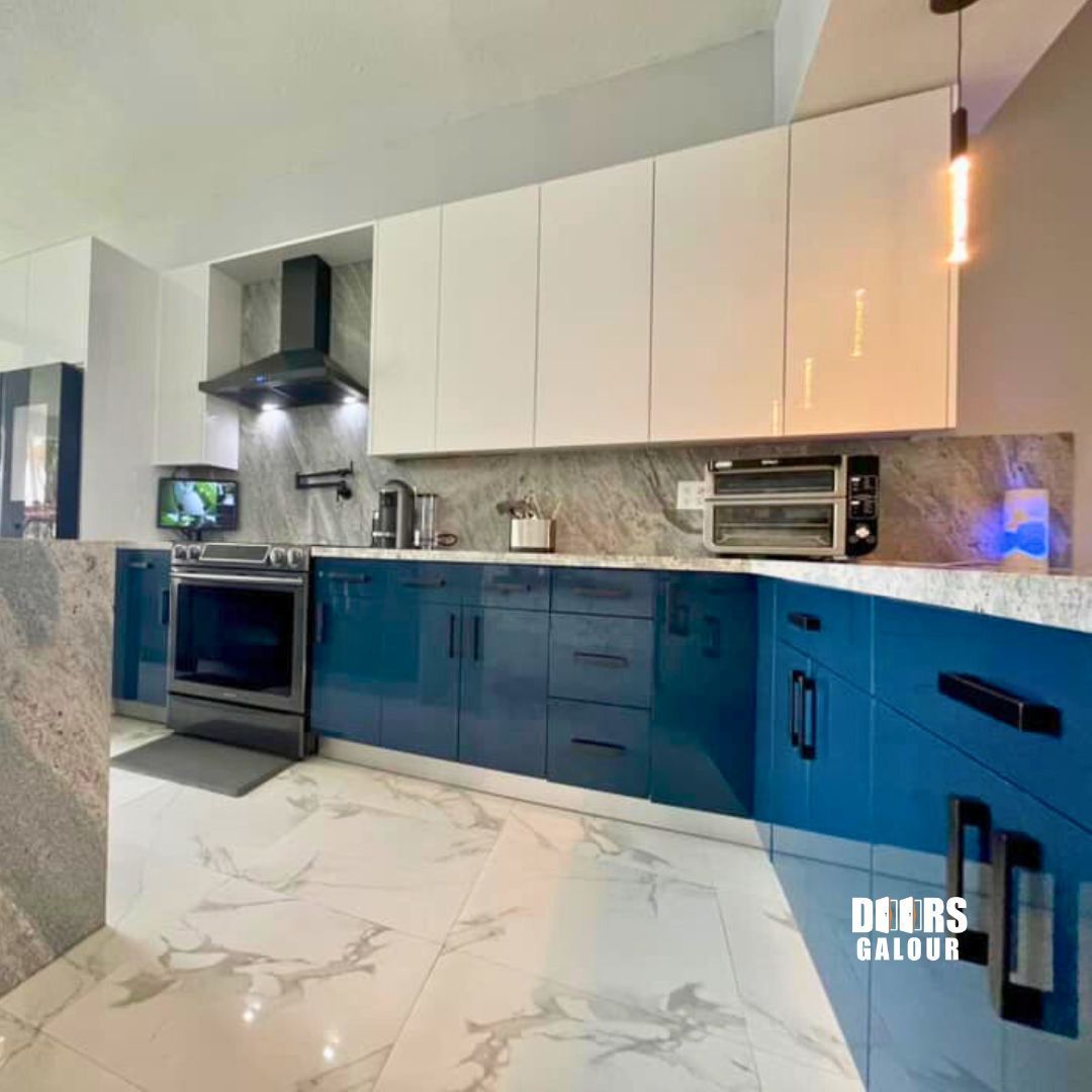 Modern open-plan kitchen and dining area with water view; white and neutral tones.