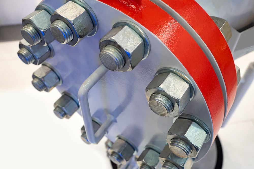 A Close Up Of A Metal Pipe With Nuts And Bolts — Illawarra Fasteners Pty Ltd In Unanderra, NSW