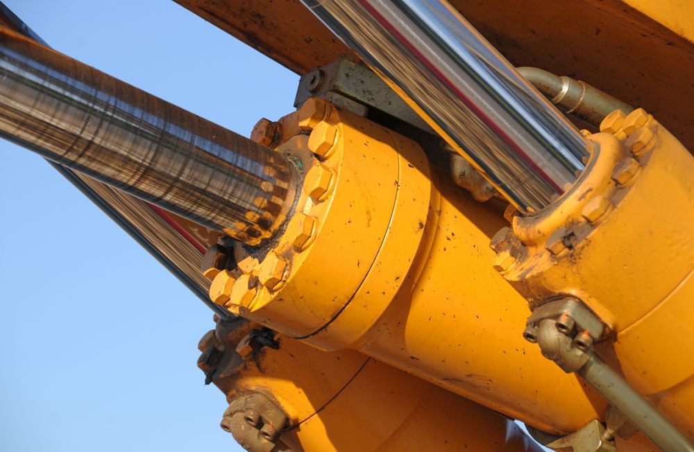 A Close Up Of A Yellow Hydraulic Cylinder — Illawarra Fasteners Pty Ltd In Unanderra, NSW