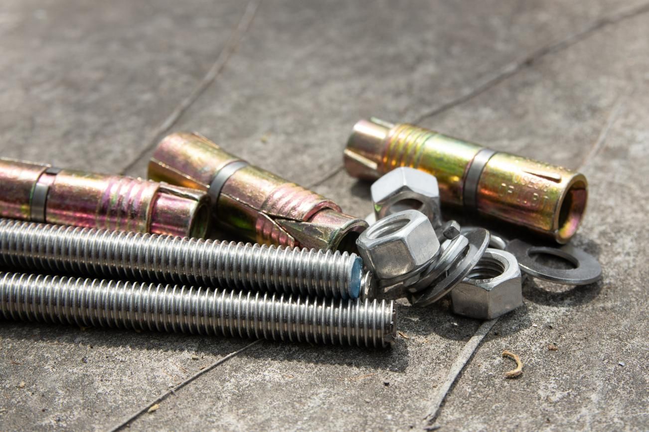 A Bunch Of Nuts And Bolts Are Laying On The Ground — Illawarra Fasteners Pty Ltd In Unanderra, NSW
