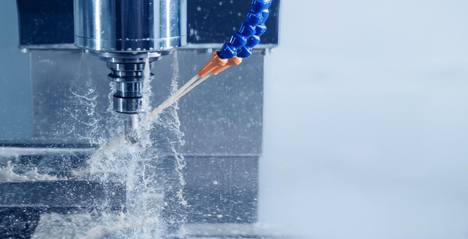 A Machine Is Cutting A Piece Of Metal With Cutting Fluid— Illawarra Fasteners Pty Ltd In Unanderra, NSW