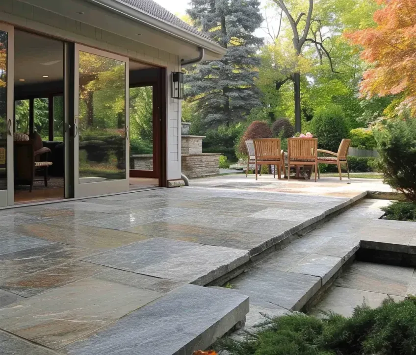 A patio with a table and chairs outside of a house