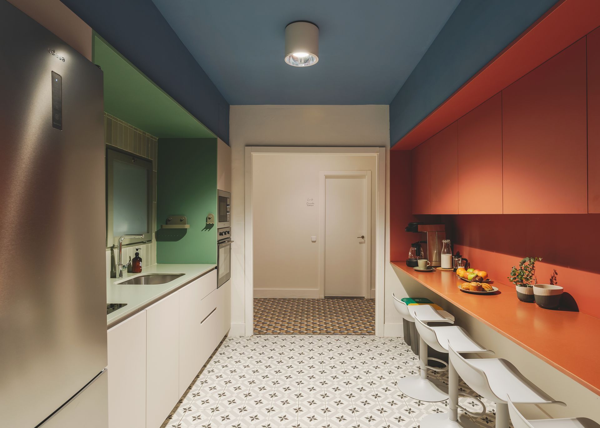 A kitchen with a blue ceiling and orange cabinets