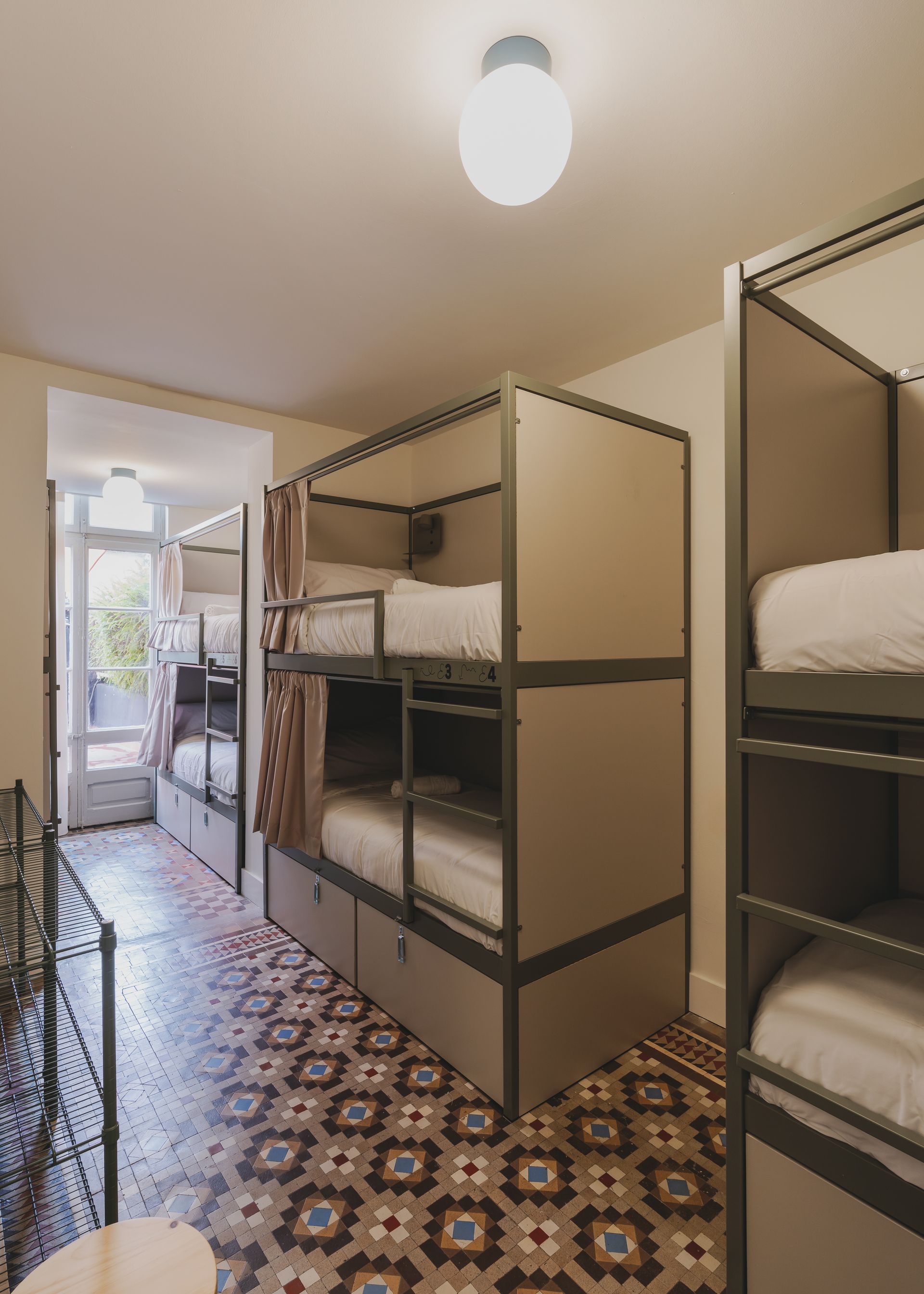 A room with bunk beds and a tiled floor