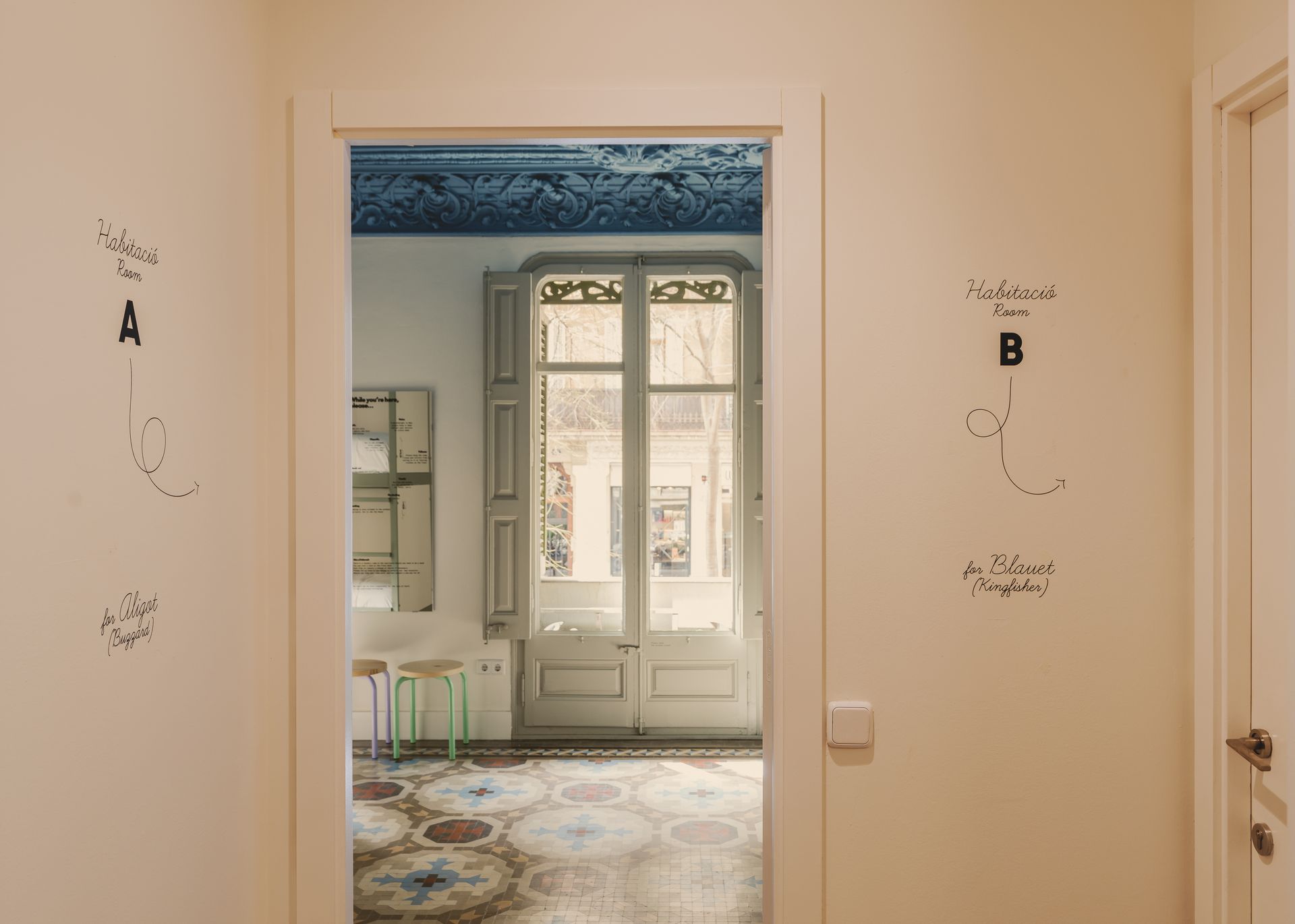 A doorway leading to a room with a window and a table.