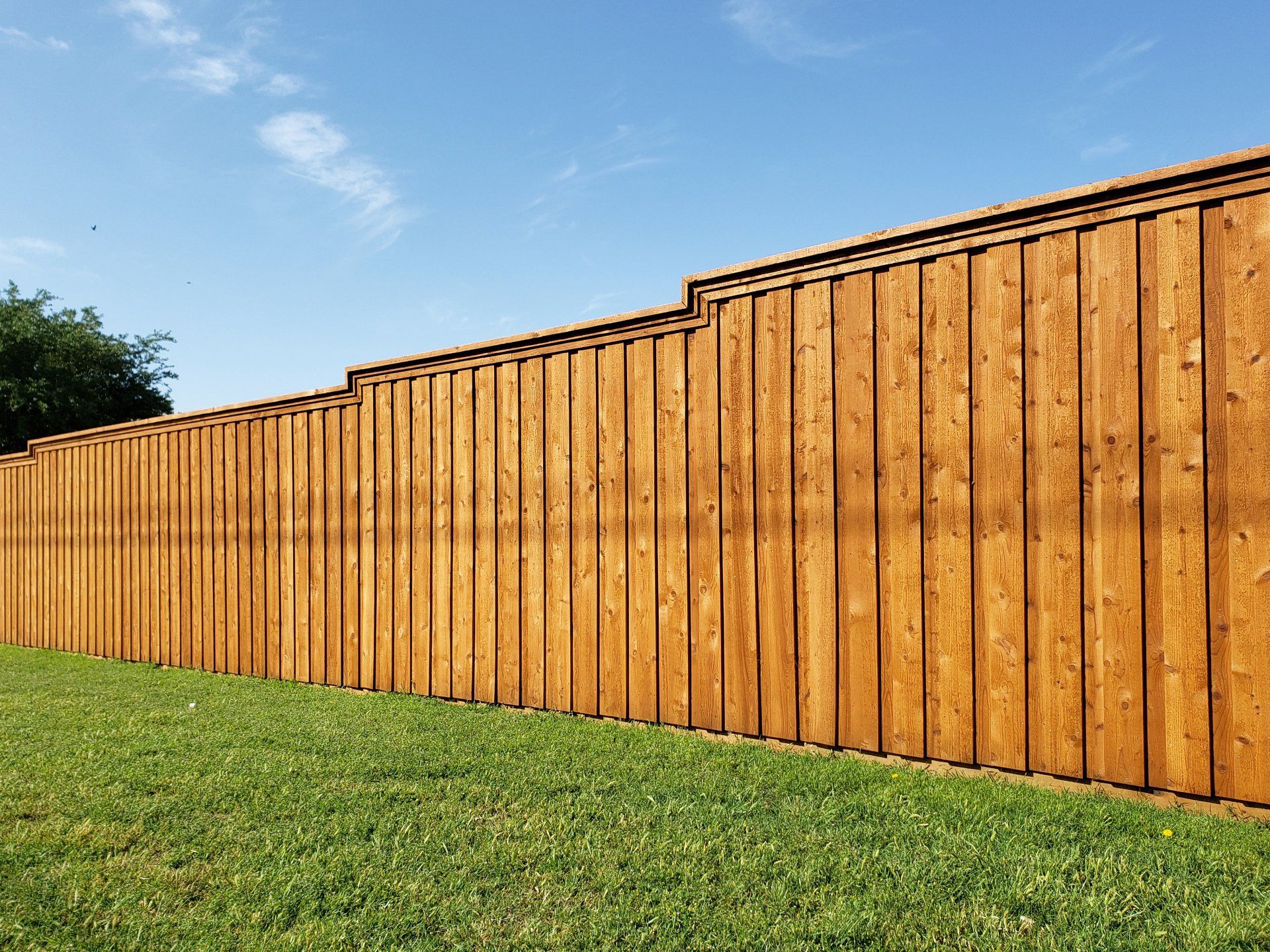 New wooden brown fence in community