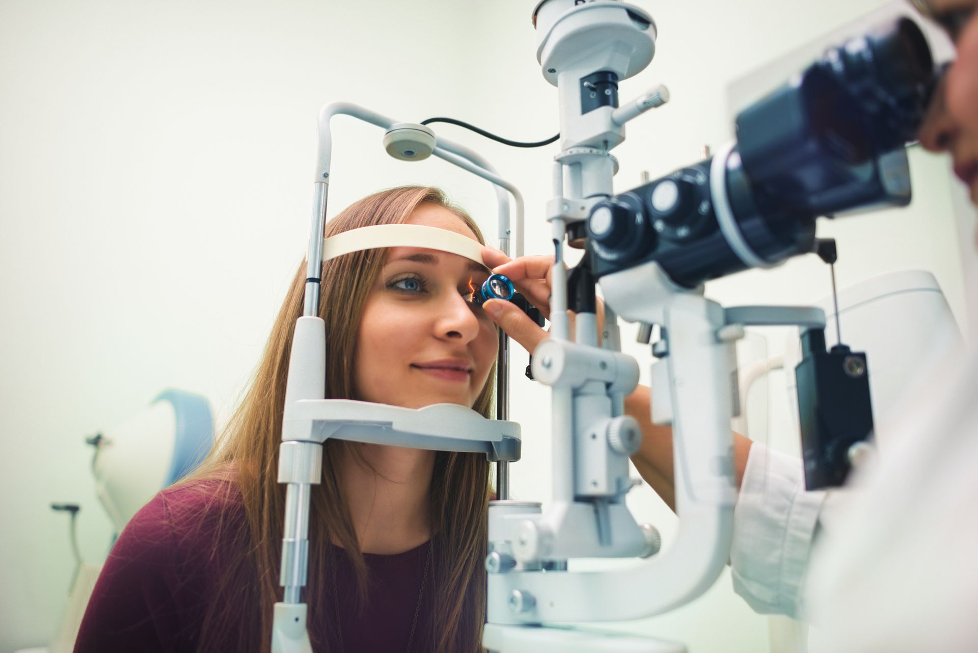 A woman is getting her eyes examined by an ophthalmologist.