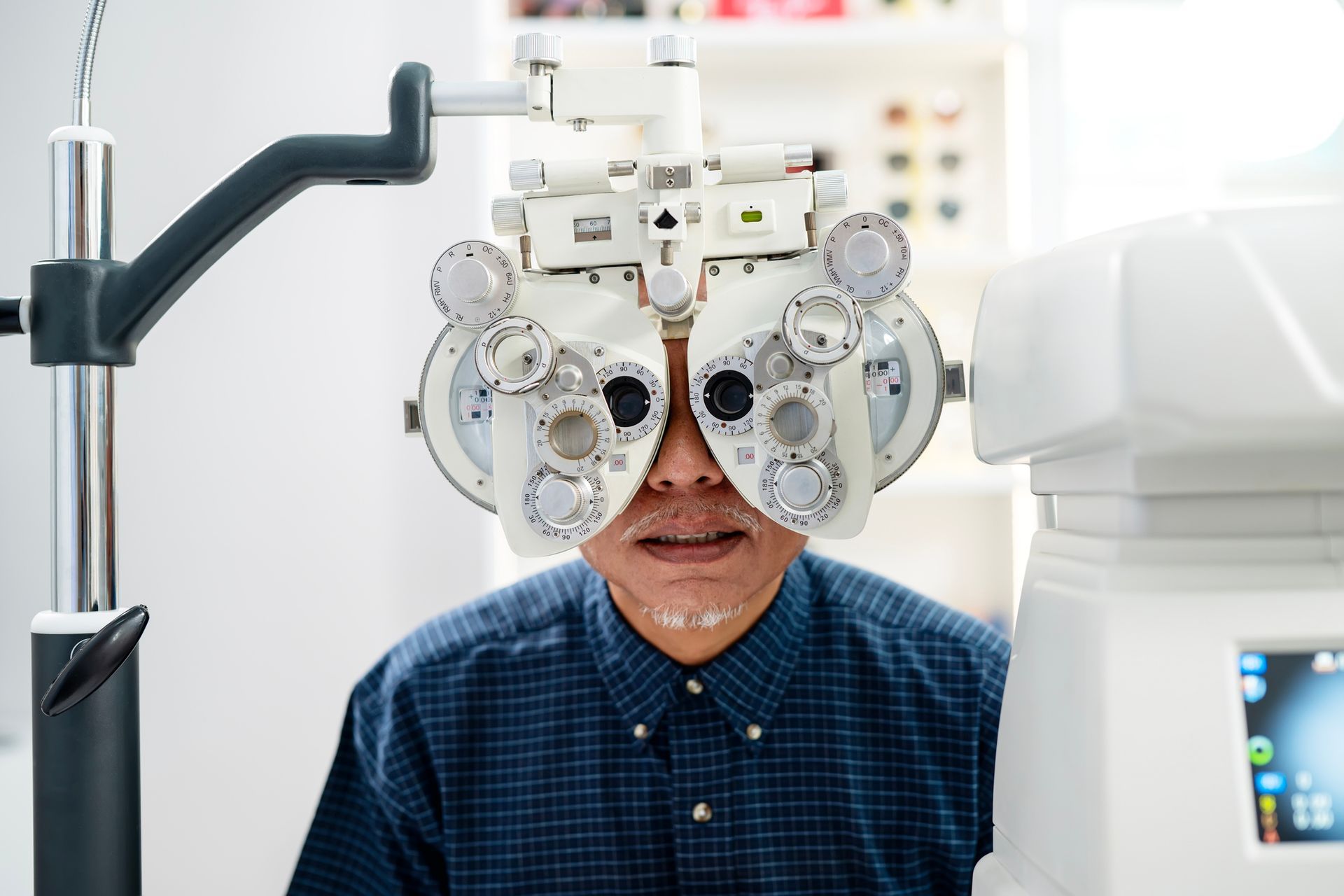 A man is getting his eyes checked by an ophthalmologist.