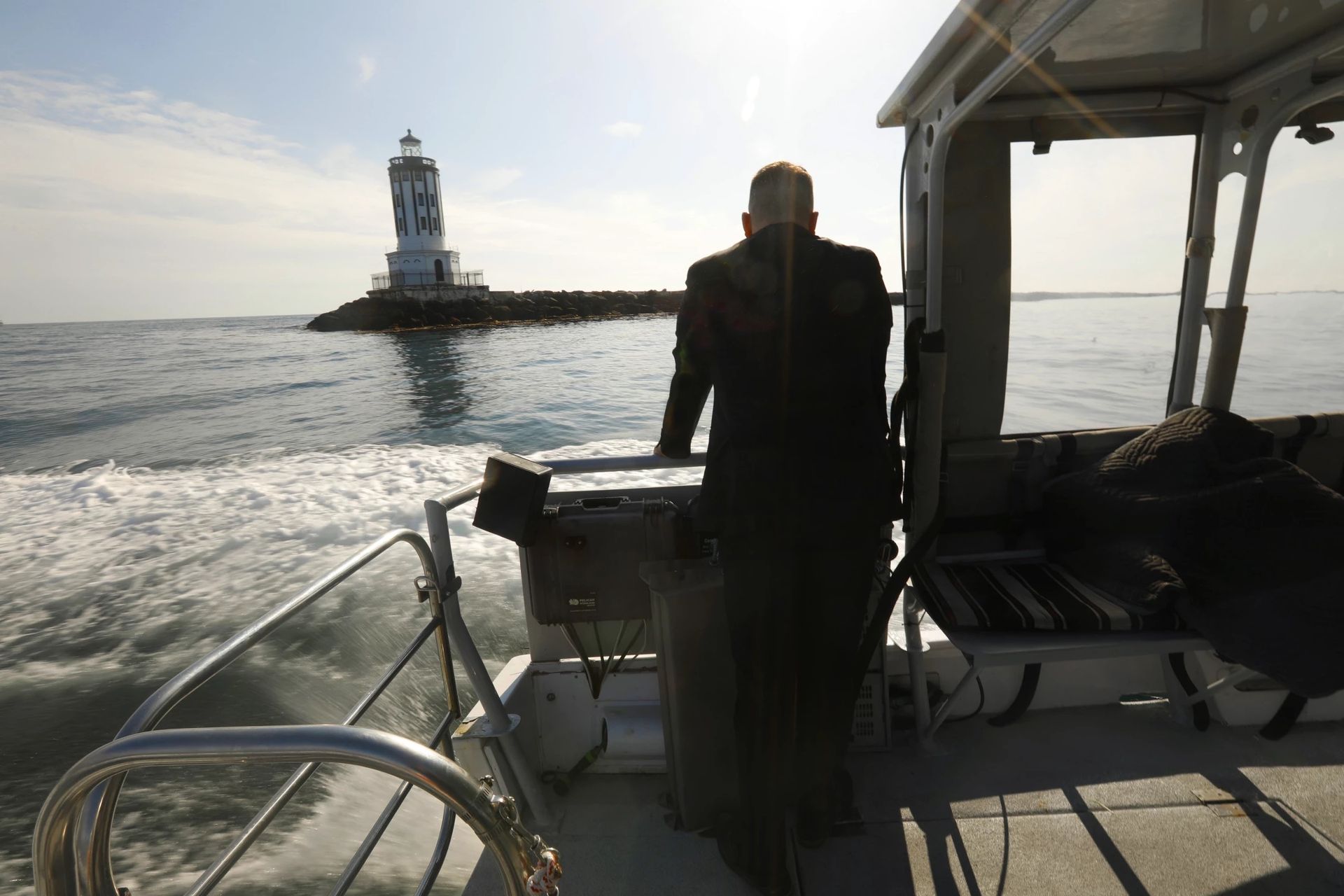(Ken on boat, facing away) “We take old ships and put them to rest at the bottom of the ocean, and that starts an ecosystem,” said funeral director Ken McKenzie. “Caskets do that too. They become a reef. It doesn’t matter whether you are in the earth or in the sea, we all go back to where we came from.” (Carolyn Cole / Los Angeles Times)