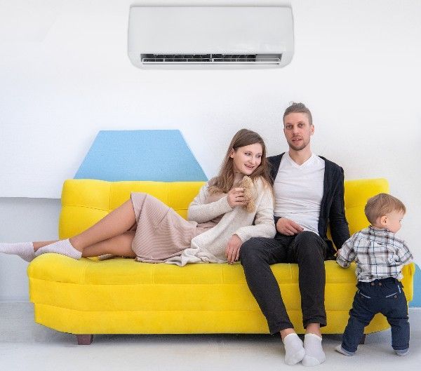 Family Relaxing on Sofa with Aircon