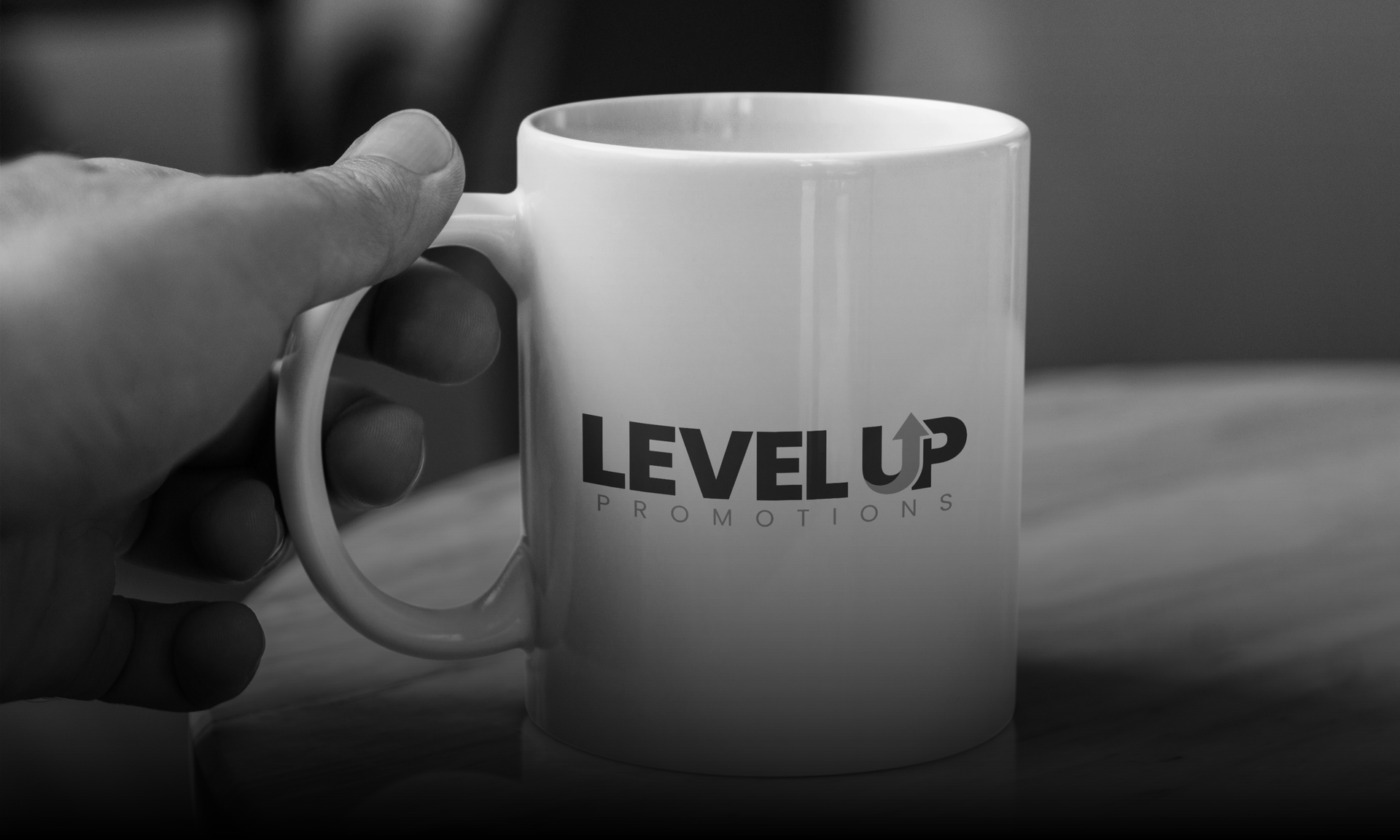 Hand holding a white mug with 